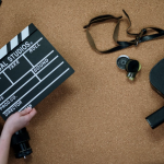 Accesorios de cine, como claqueta y cámaras, que ilustran el impacto de la tecnología en el cine